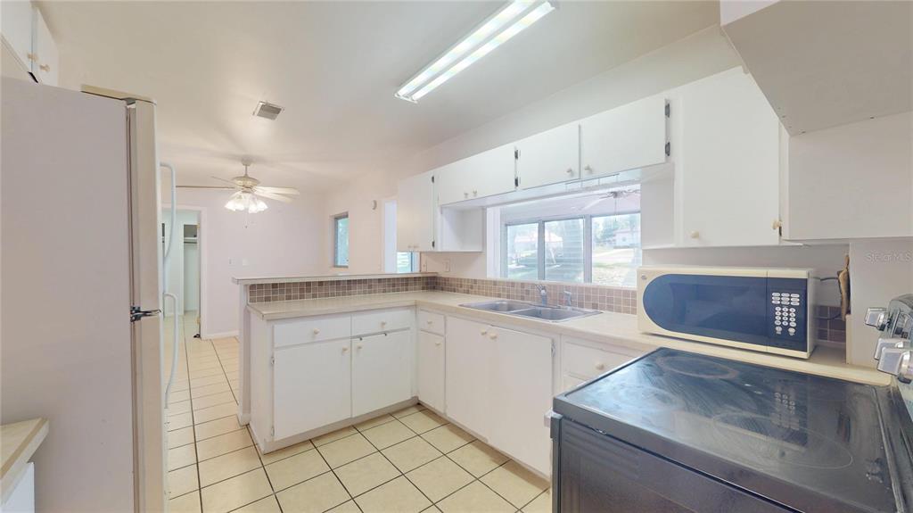 121 North Seminole Avenue Inverness, FL 34450 - Photo 7 of 47 a kitchen with a sink cabinets and window