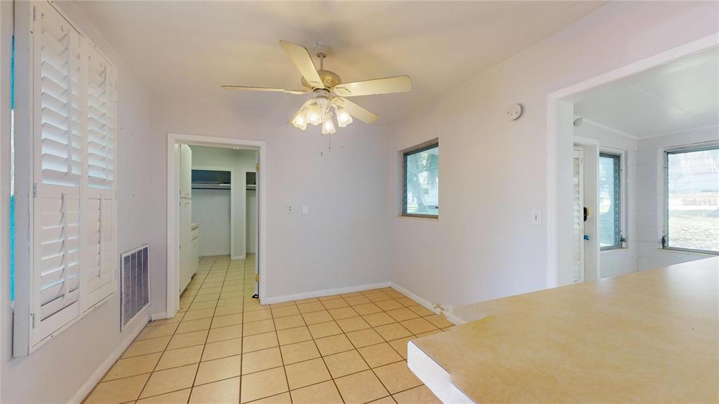 121 North Seminole Avenue Inverness, FL 34450 - Photo 9 of 47 a bedroom with a bed and a chandelier