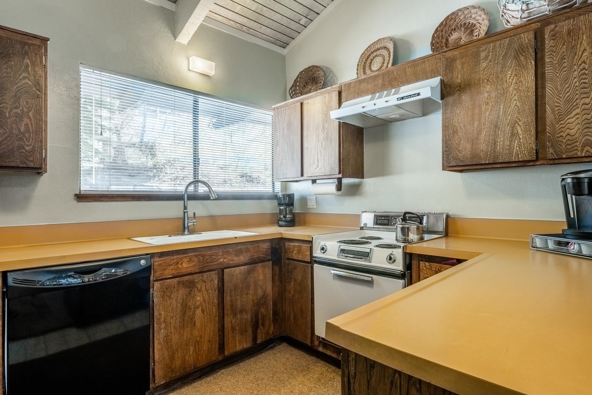 94 John Muir Road, Unit 132 Mammoth Lakes, CA 93546 - Photo 17 of 58 a kitchen with a sink a stove and cabinets