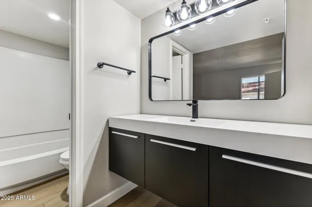 a bathroom with a sink and a mirror