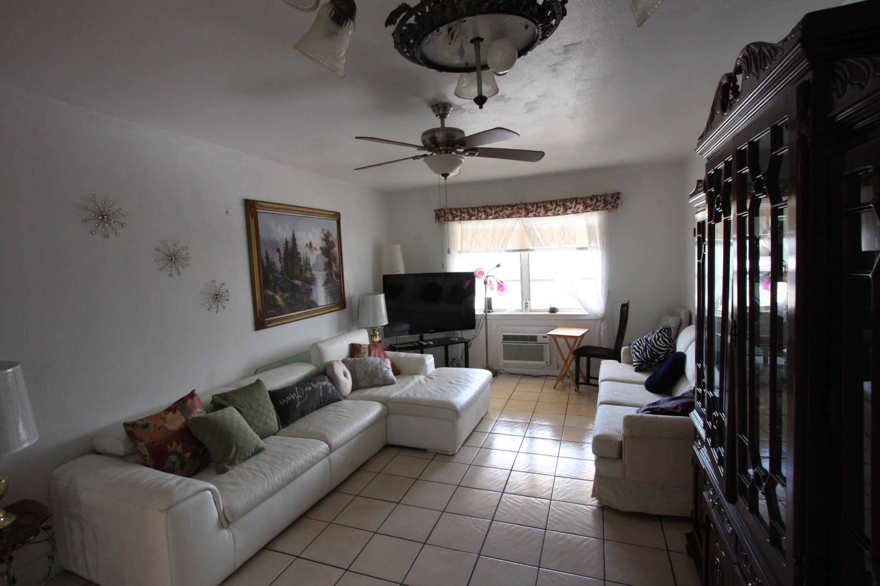 1050 East Sample Road, Unit 307 Pompano Beach, FL 33064 - Photo 13 of 28 a living room with furniture and a fireplace