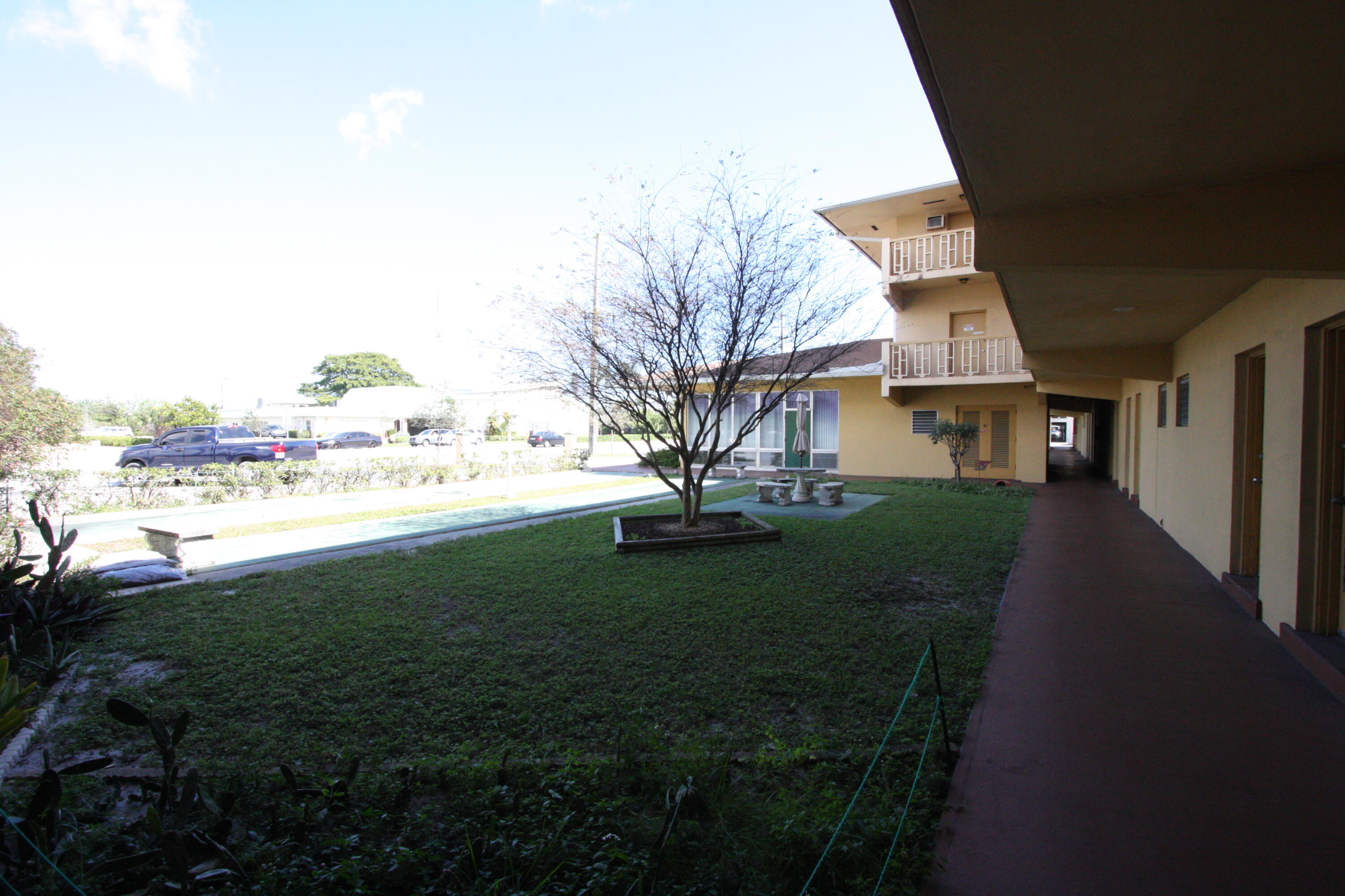 1050 East Sample Road, Unit 307 Pompano Beach, FL 33064 - Photo 7 of 28 a view of a garden with a house