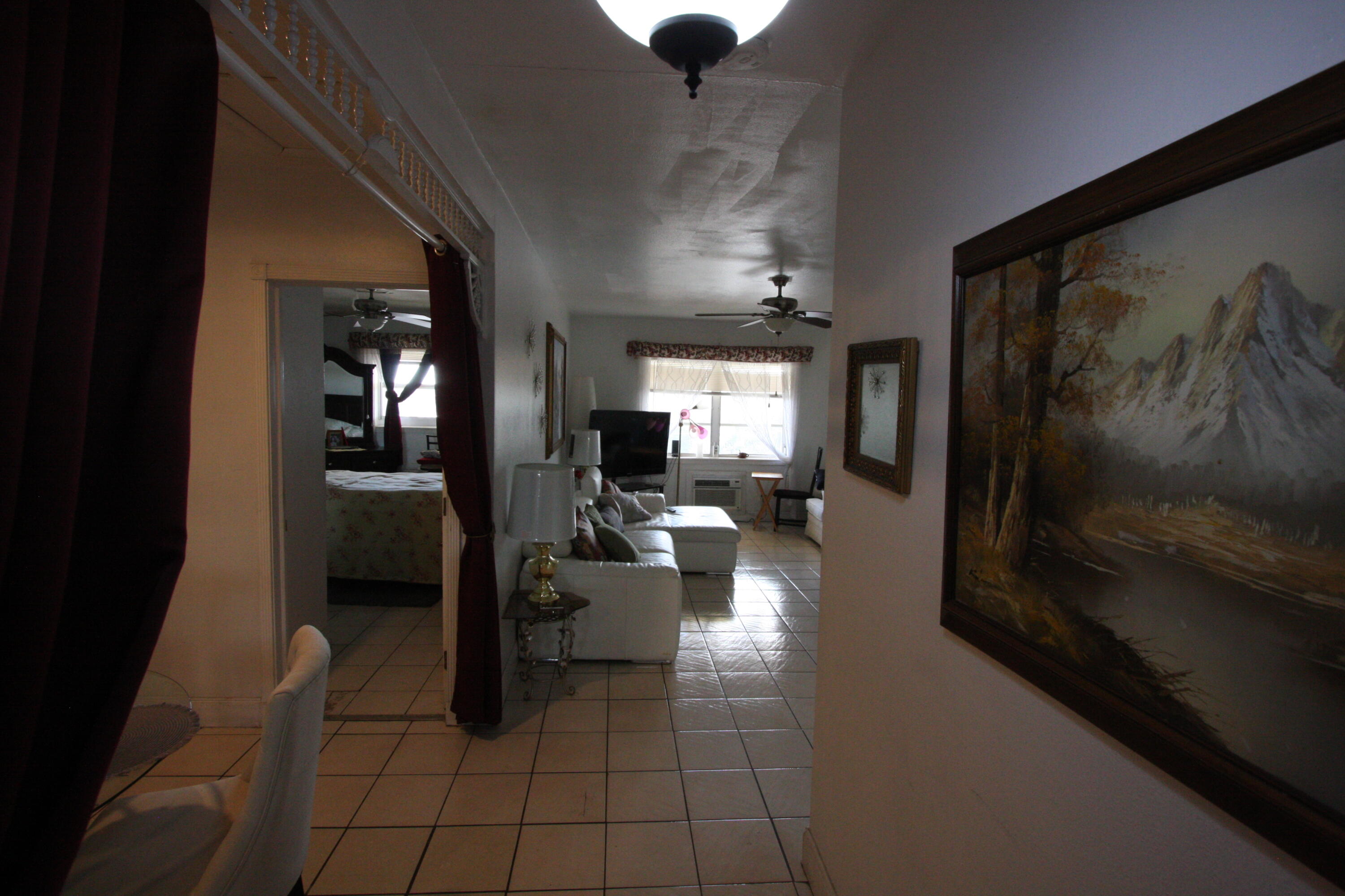 1050 East Sample Road, Unit 307 Pompano Beach, FL 33064 - Photo 9 of 28 a living room with furniture and a flat screen tv
