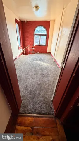 a view of a hardwood floor and an entrance door