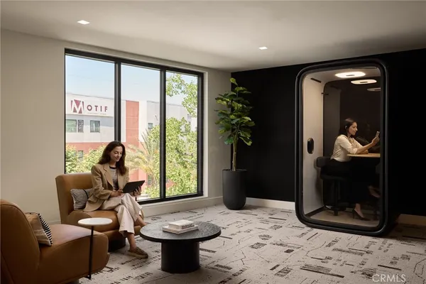 a living room with furniture and large windows