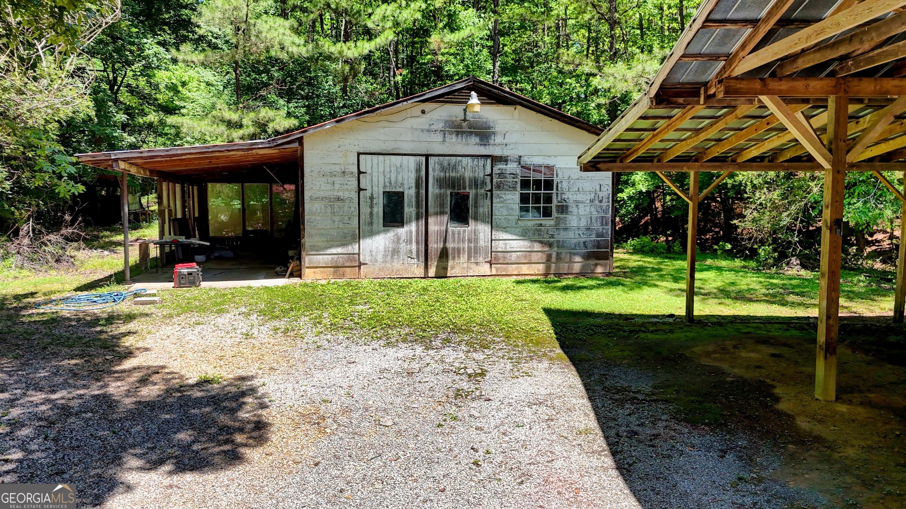 973 Barker Road Southwest Rome, GA 30165 - Photo 11 of 39 a front view of a house with a yard table and chairs