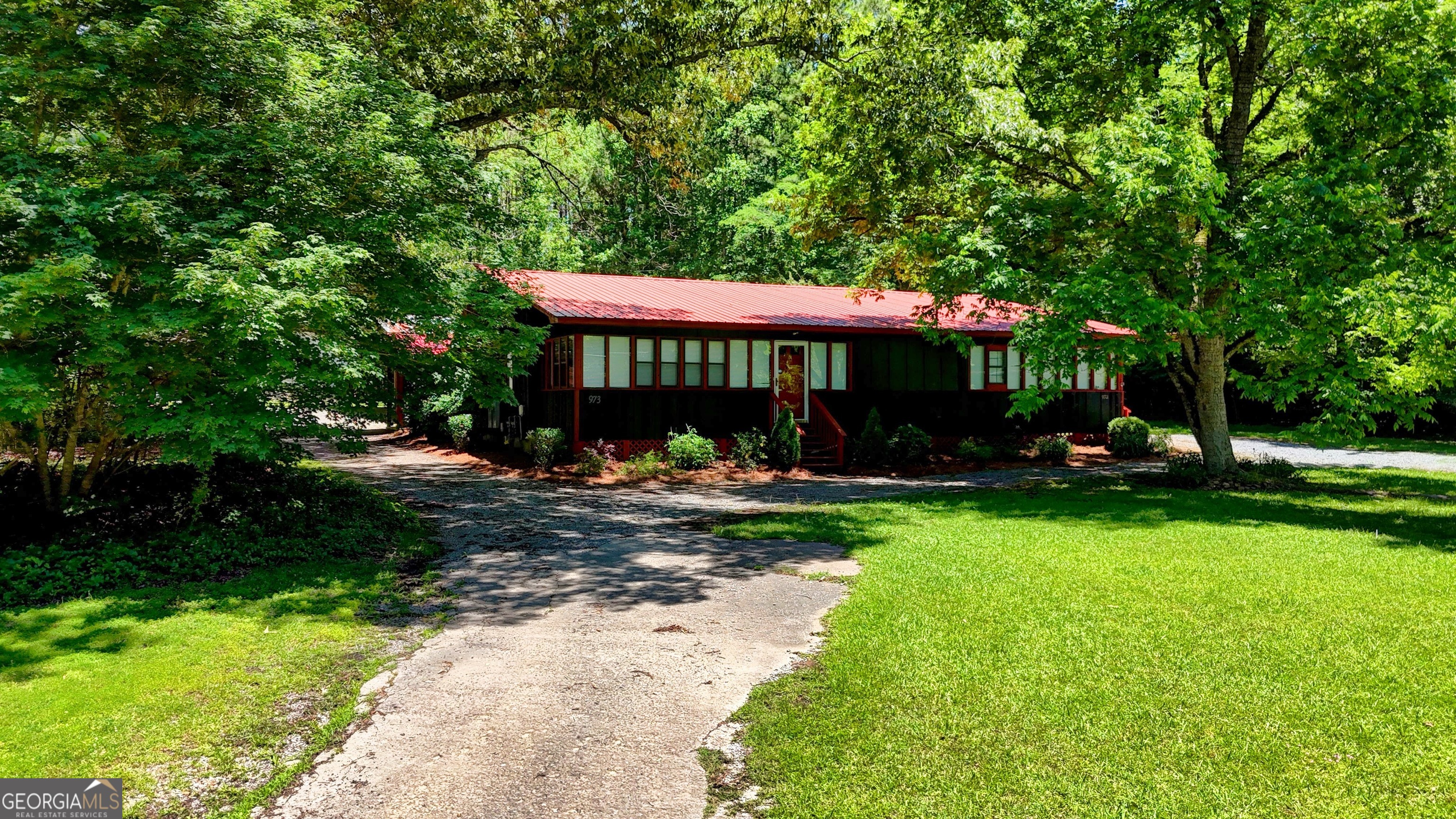 973 Barker Road Southwest Rome, GA 30165 - Photo 2 of 39 a view of a table and chairs under an umbrella