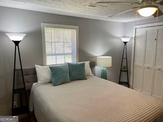 973 Barker Road Southwest Rome, GA 30165 - Photo 24 of 39 a bedroom with a bed and a lamp