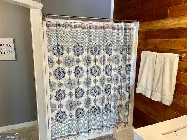 973 Barker Road Southwest Rome, GA 30165 - Photo 25 of 39 a bathroom with a shower curtain and a sink