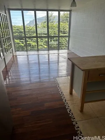 a view of entryway and hall with wooden floor