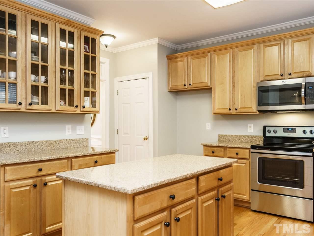 4408 Thistlehill Court Raleigh, NC 27616 - Photo 10 of 25 a kitchen with stainless steel appliances a stove a microwave and cabinets