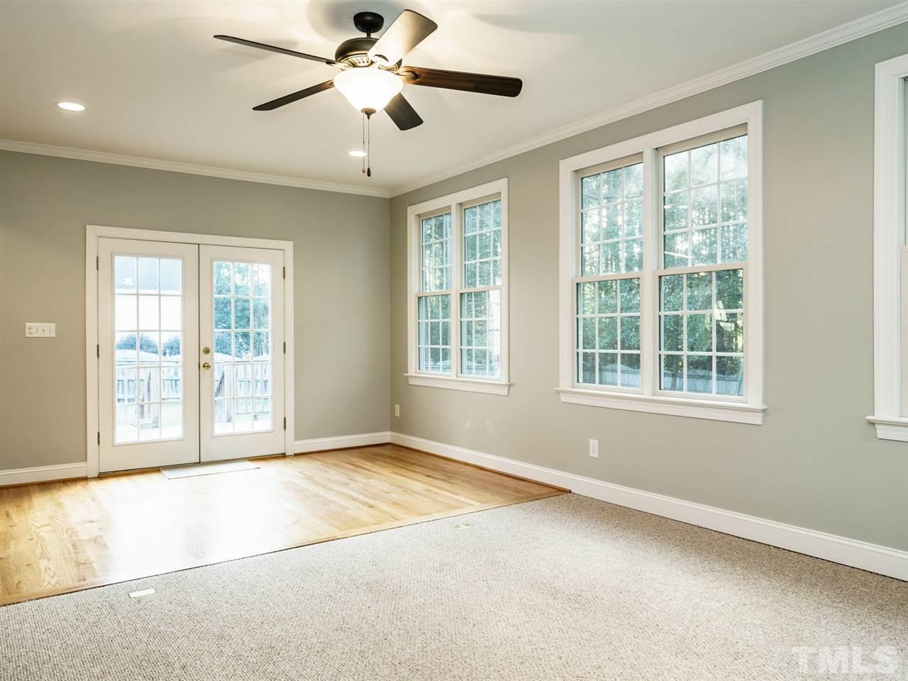 4408 Thistlehill Court Raleigh, NC 27616 - Photo 13 of 25 a view of an empty room with a window and a kitchen