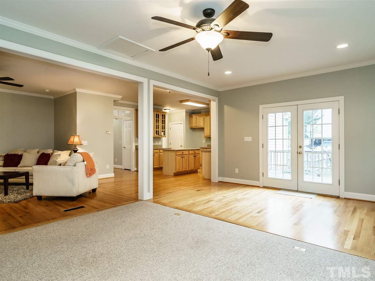 4408 Thistlehill Court Raleigh, NC 27616 - Photo 14 of 25 a living room with furniture and a large window with kitchen view