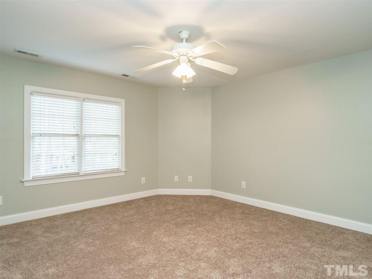 4408 Thistlehill Court Raleigh, NC 27616 - Photo 15 of 25 an empty room with windows and fan