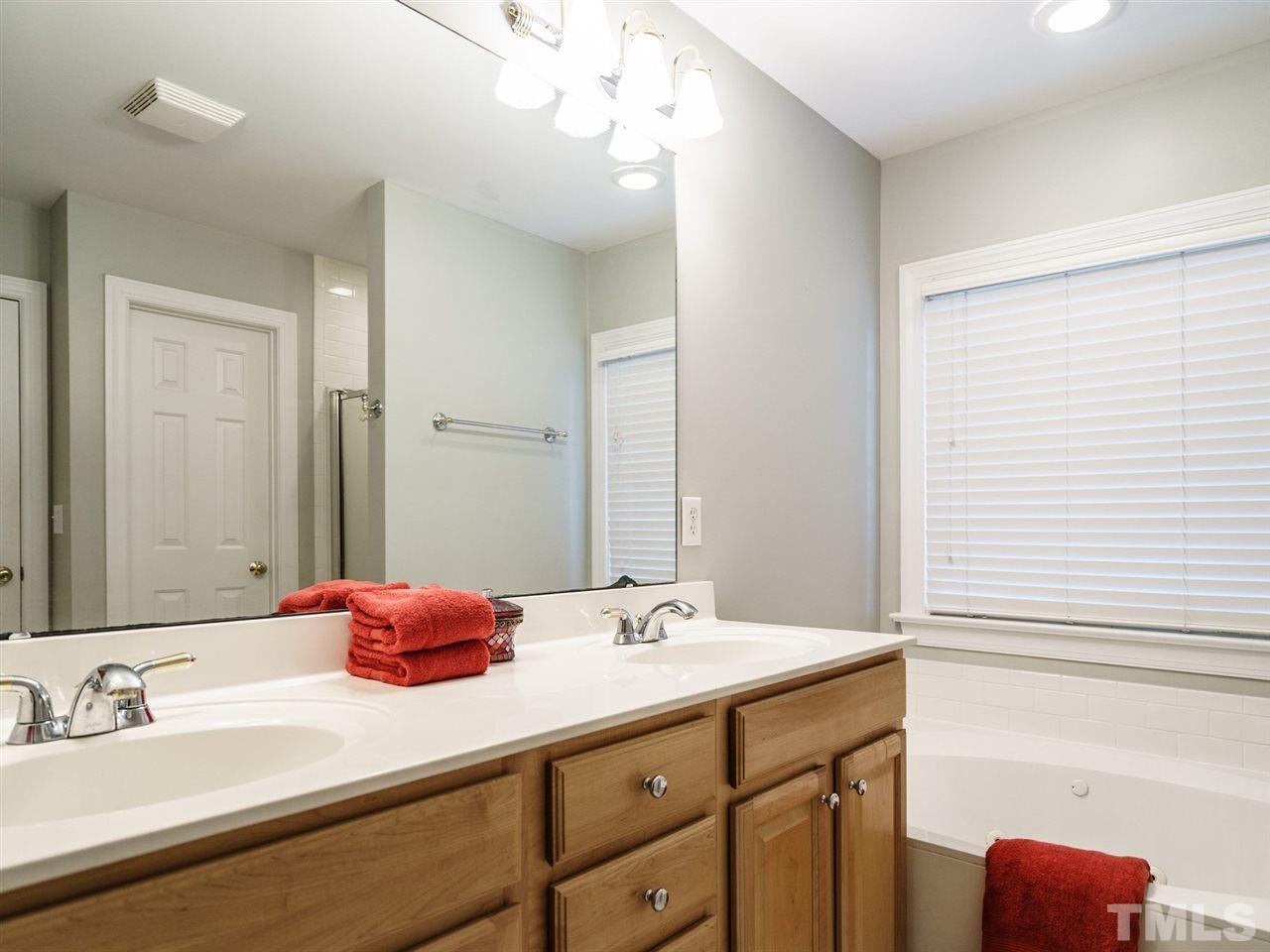 4408 Thistlehill Court Raleigh, NC 27616 - Photo 16 of 25 a bathroom with a sink and a mirror