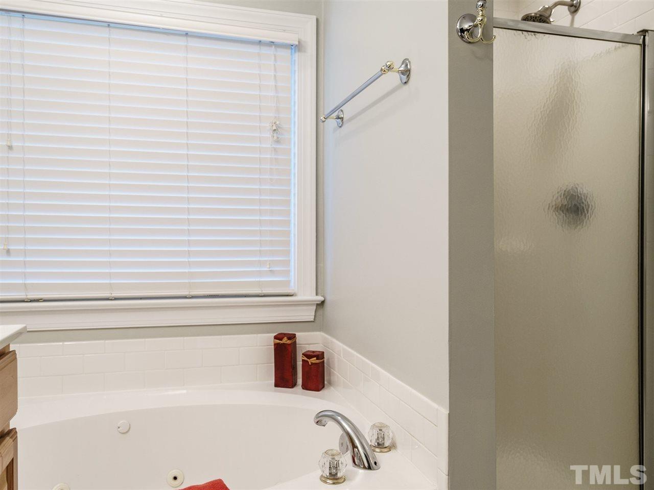 4408 Thistlehill Court Raleigh, NC 27616 - Photo 17 of 25 a bathroom with a sink and a bathtub