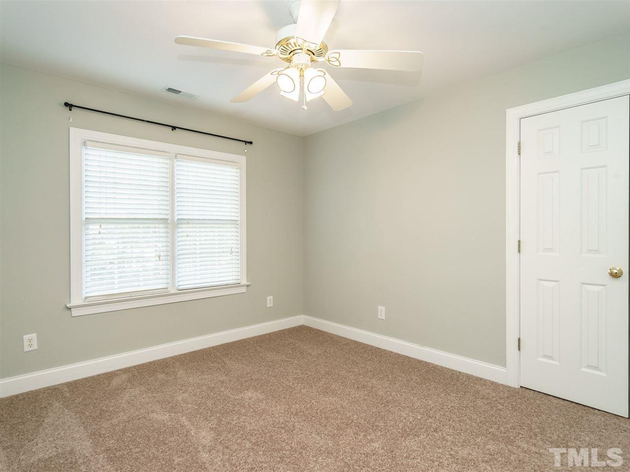 4408 Thistlehill Court Raleigh, NC 27616 - Photo 19 of 25 an empty room with windows and fan