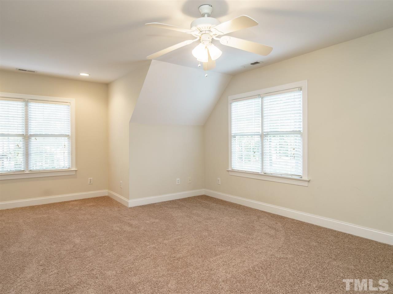 4408 Thistlehill Court Raleigh, NC 27616 - Photo 20 of 25 an empty room with chandelier fan and windows