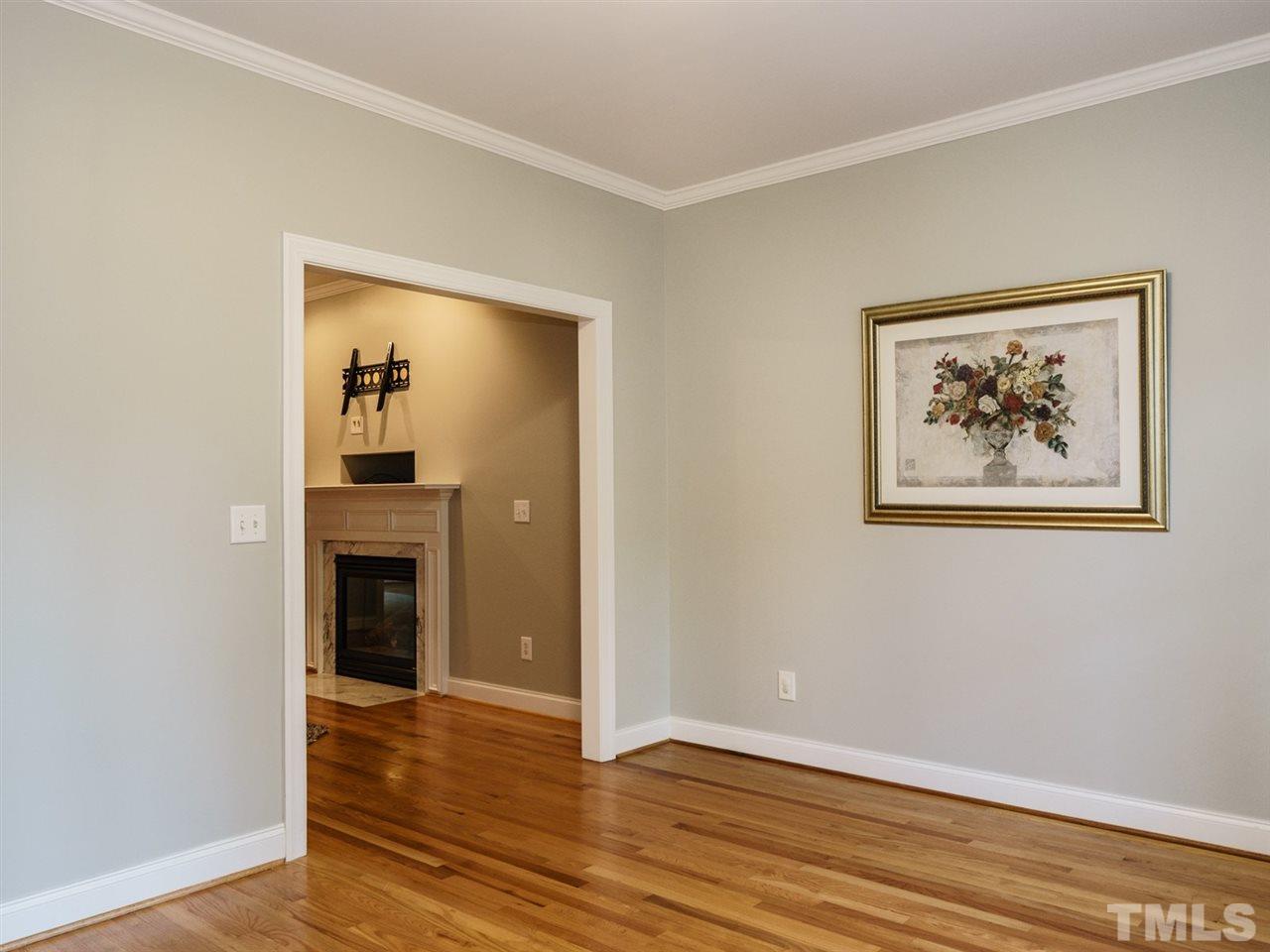 4408 Thistlehill Court Raleigh, NC 27616 - Photo 6 of 25 a view of an empty room with wooden floor and a window