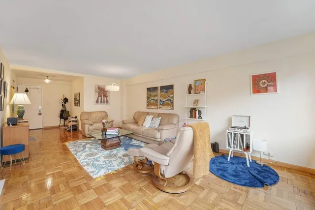 a living room with furniture a table and chair