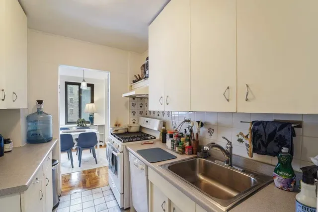 a kitchen with a sink stove and cabinets