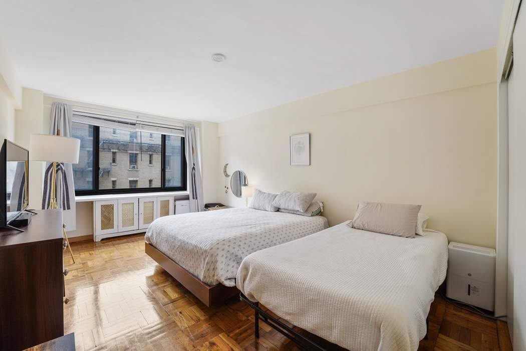 Undisclosed Address Manhattan, NY 10065 - Photo 7 of 10 a bedroom with two beds and a large window