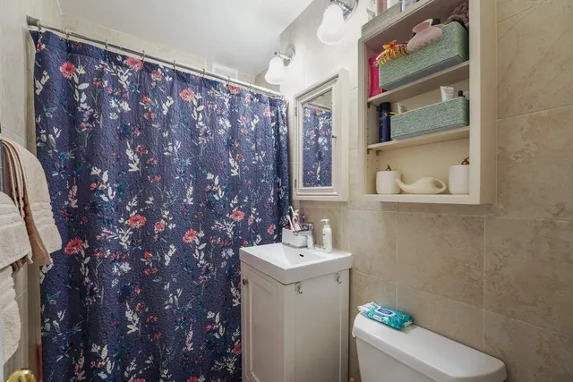 a bedroom with a bed and a mirror