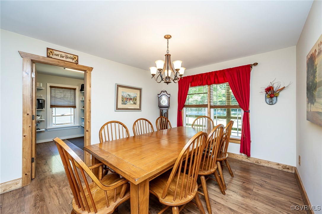 4275 Rockhill Road Mechanicsville, VA 23111 - Photo 23 of 43 a dining room with furniture a chandelier and wooden floor