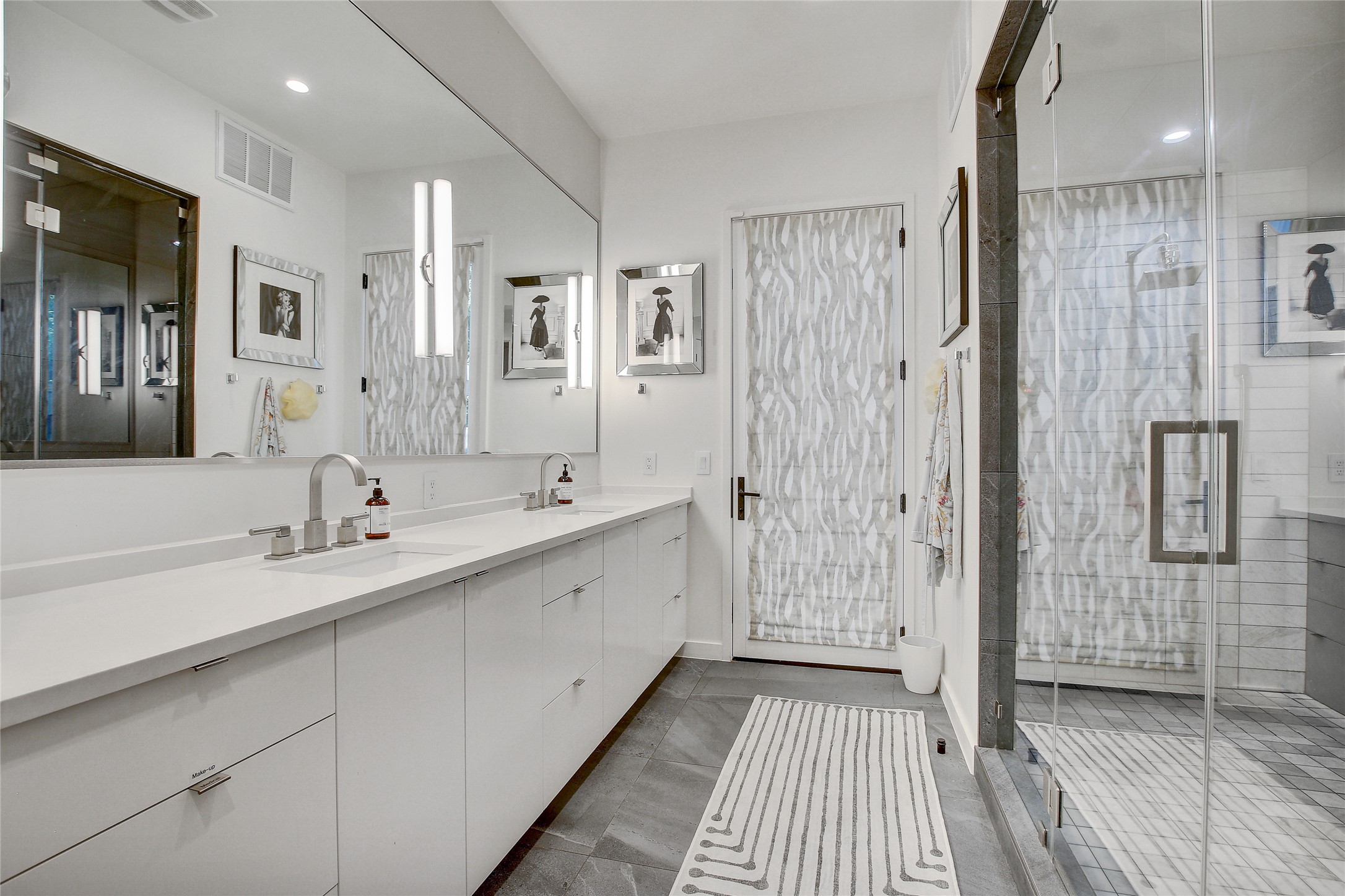 2006 Ford Street Austin, TX 78704 - Photo 17 of 40 Full bath featuring double vanity, a stall shower, recessed lighting, and dark tile patterned floors