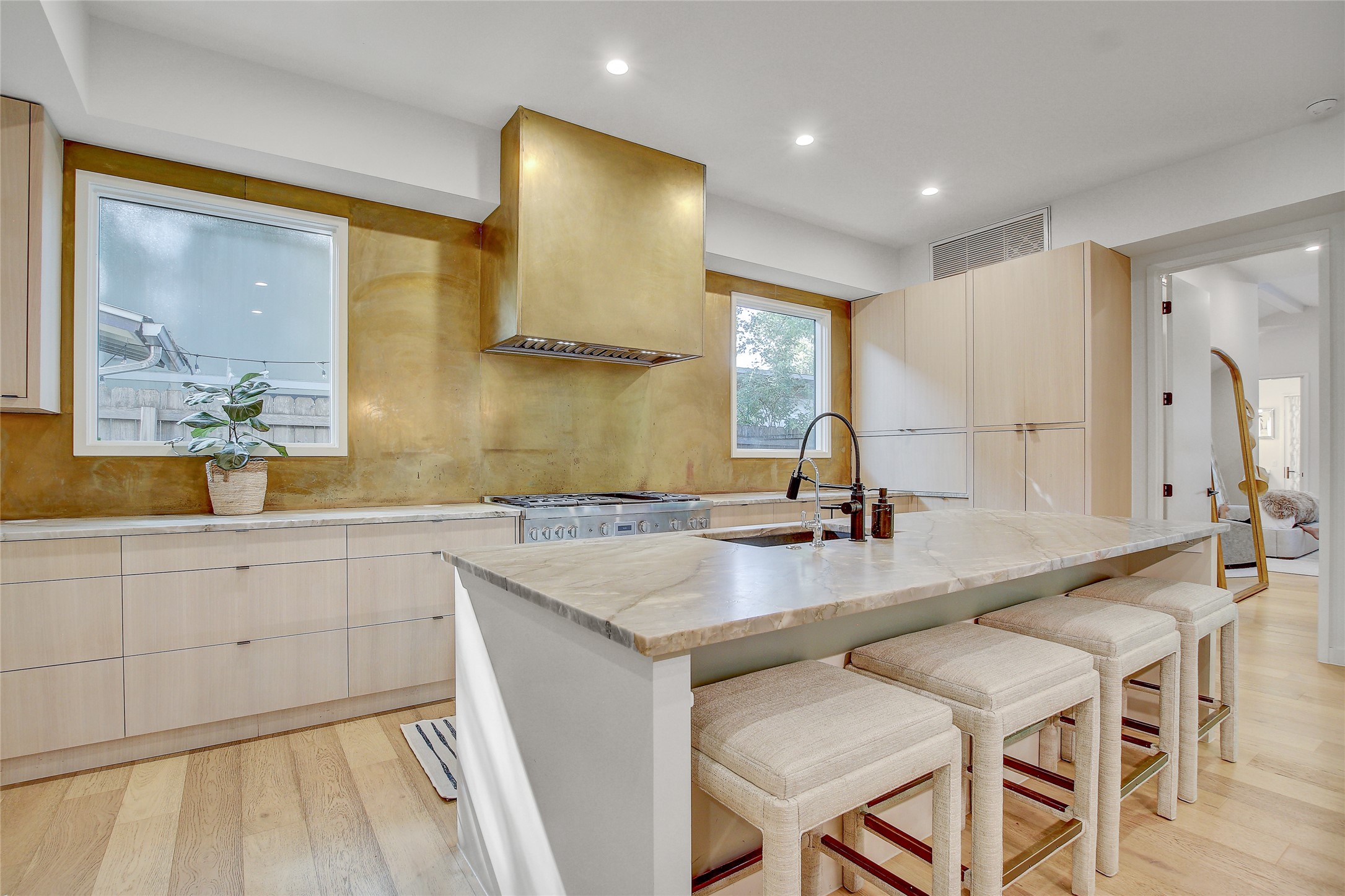 2006 Ford Street Austin, TX 78704 - Photo 10 of 40 Kitchen featuring quartz counter tops and metallic gold back splash