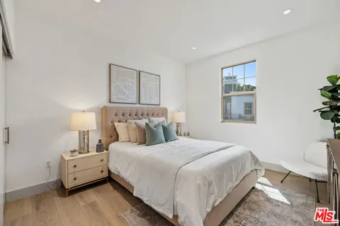 a bedroom with a bed and a lamp