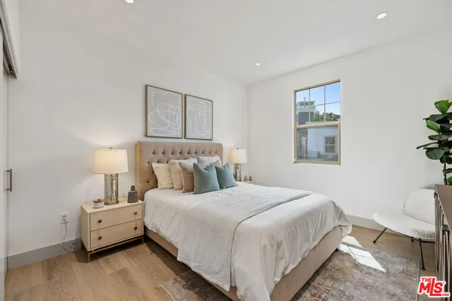 a bedroom with a bed and a lamp