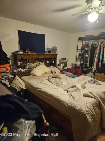 a bed sitting in a bedroom next to a computer on a desk