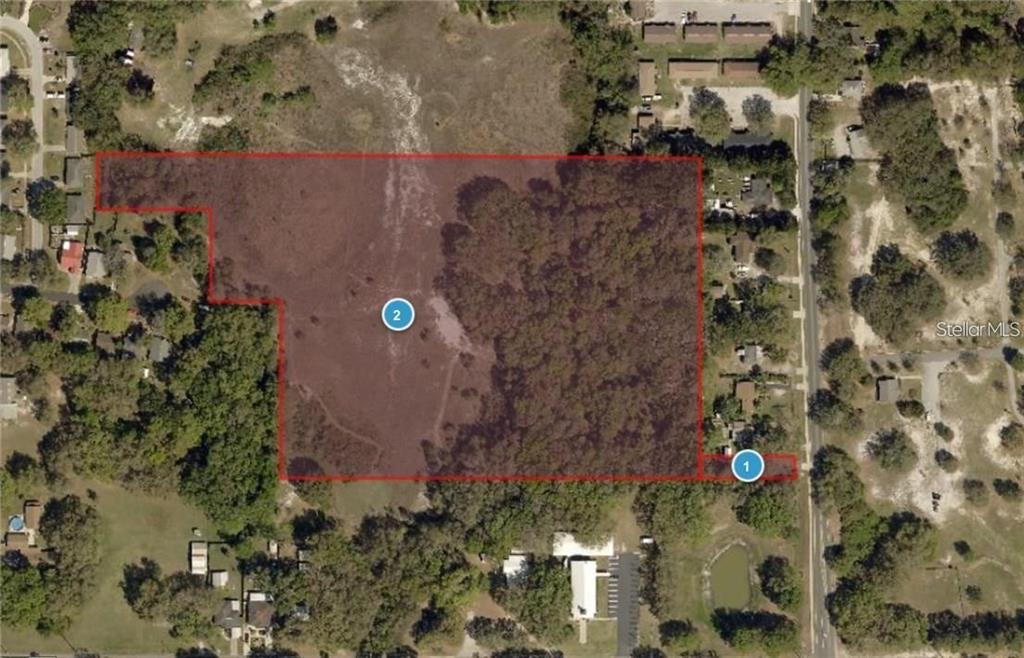 Thomas Avenue Leesburg, FL 34748 - Photo 1 of 4 an aerial view of house with outdoor space