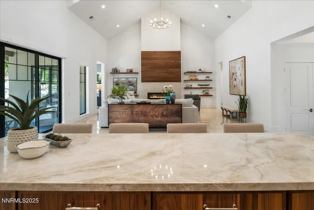 a living room with furniture a large window and a flat screen tv