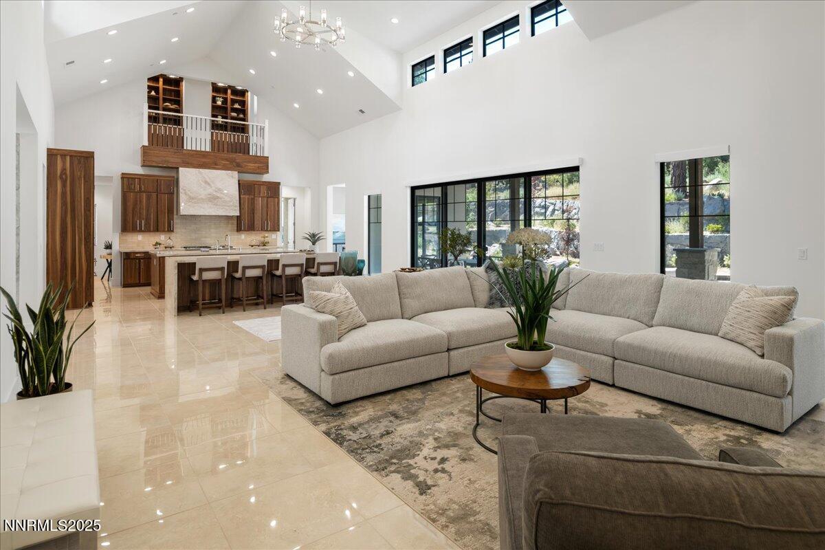 20555 Latour Way Reno, NV 89511 - Photo 12 of 59 a living room with furniture a large window and a flat screen tv