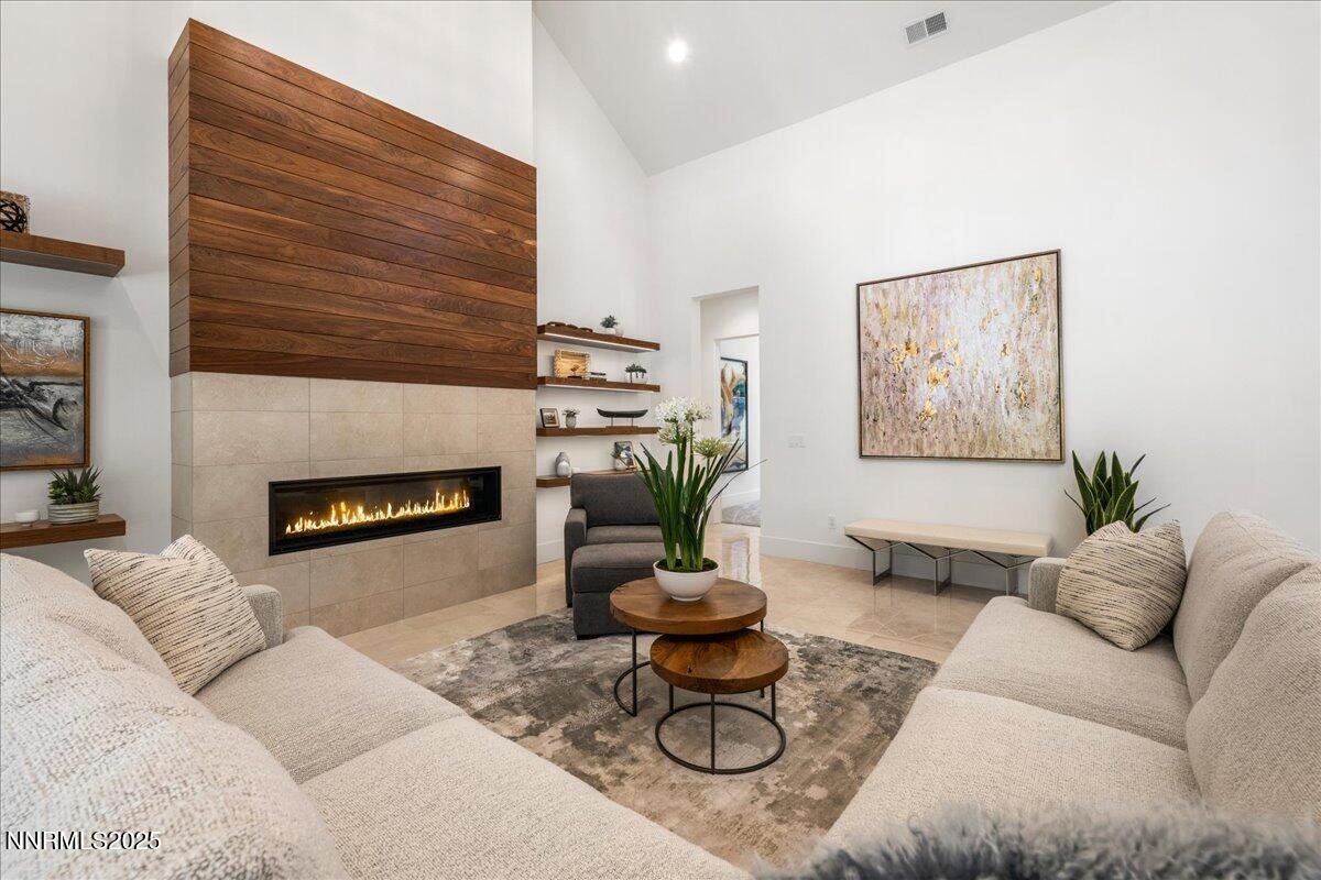20555 Latour Way Reno, NV 89511 - Photo 9 of 59 a living room with furniture kitchen view and a fireplace