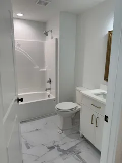 a bathroom with a toilet sink and shower