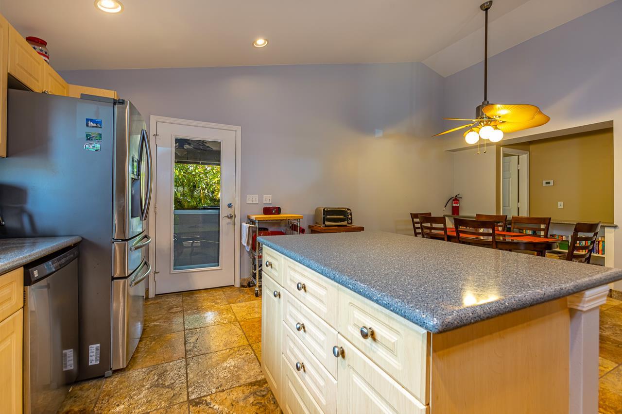 79 Molehulehu Loop Kahului, HI 96732 - Photo 13 of 29 a kitchen with kitchen island a counter top space appliances and a ceiling fan