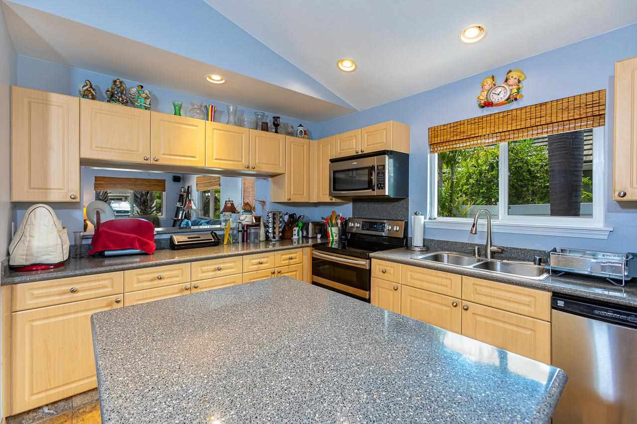 79 Molehulehu Loop Kahului, HI 96732 - Photo 10 of 29 a kitchen with stainless steel appliances a sink a stove a refrigerator cabinets and a counter top space