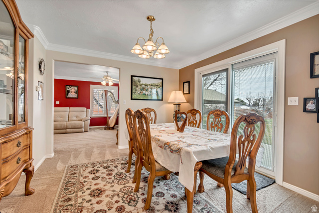1697 North 500 West Mapleton, UT 84664 - Photo 9 of 50 Dining area featuring light colored carpet, suspended lighting, crown molding, and ceiling fan
