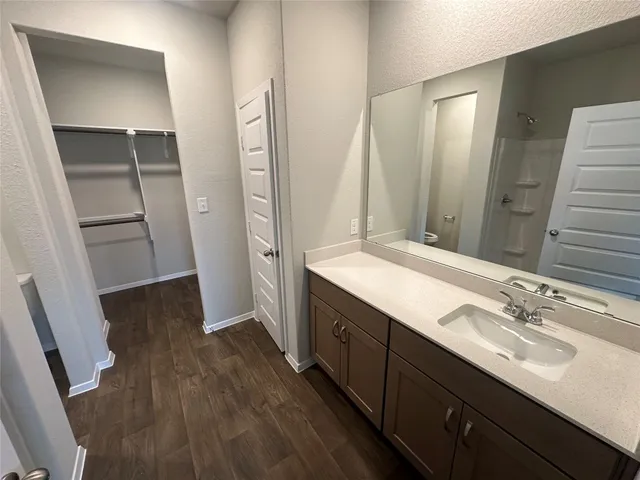 a bathroom with a shower and a sink
