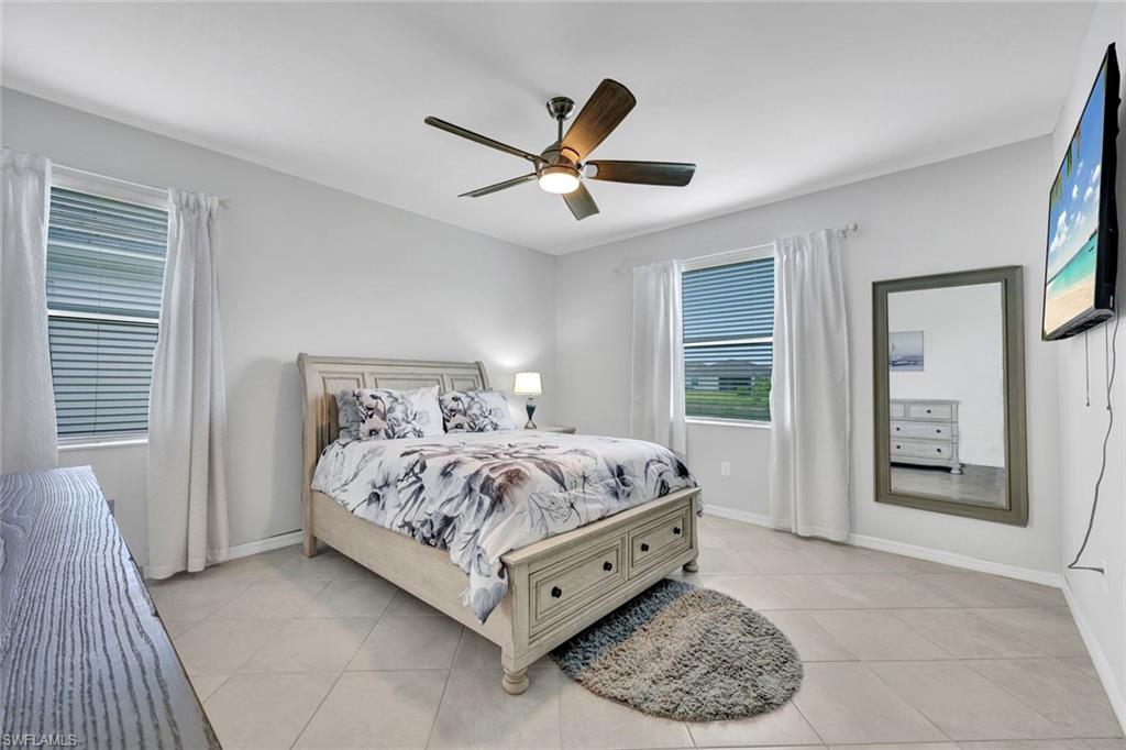 2622 Scarlet Way Naples, FL 34120 - Photo 8 of 24 a bed room with a bed and a window