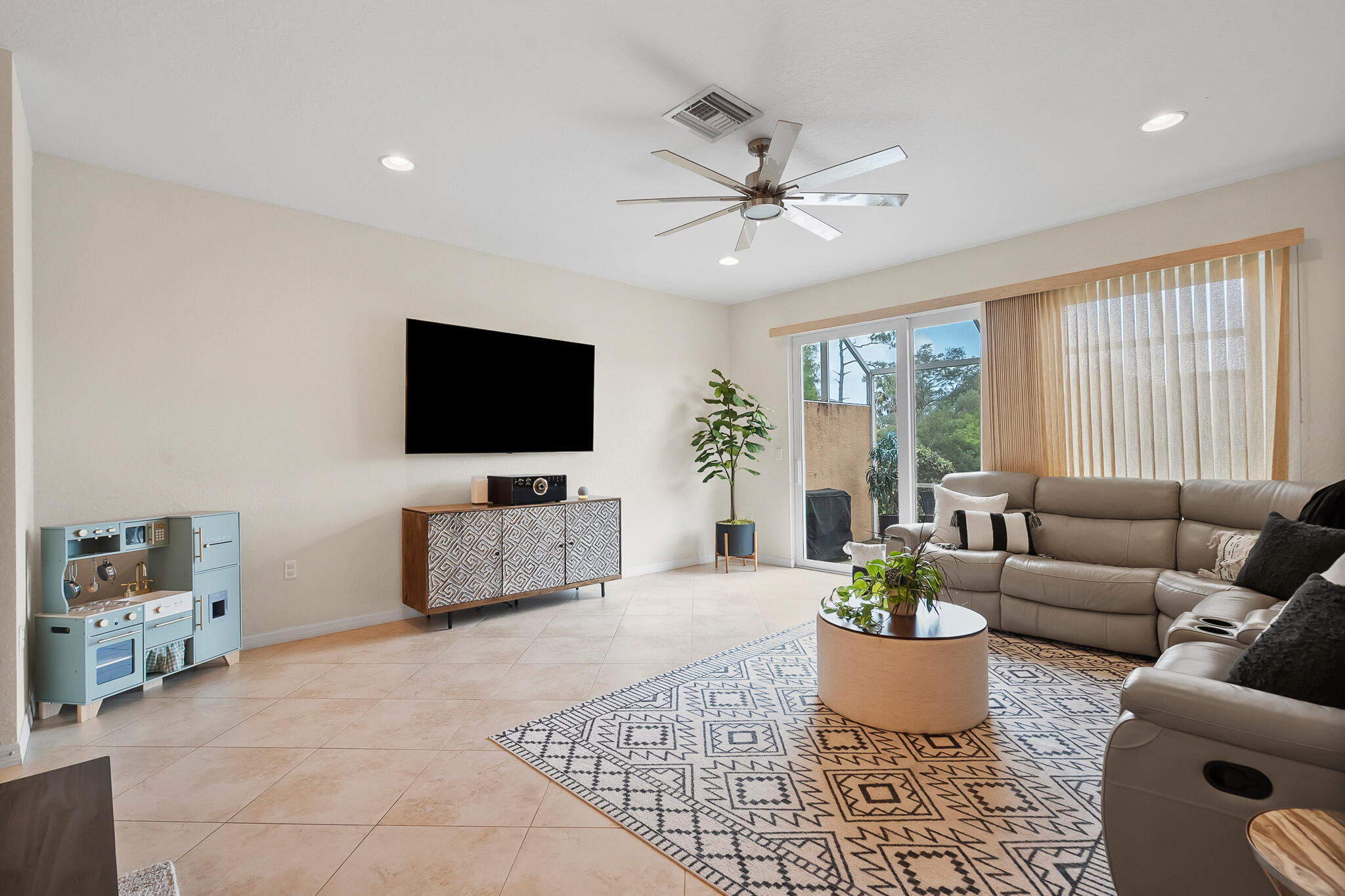 524 Southwest Glen Crest Way Stuart, FL 34997 - Photo 11 of 43 a living room with furniture and a flat screen tv