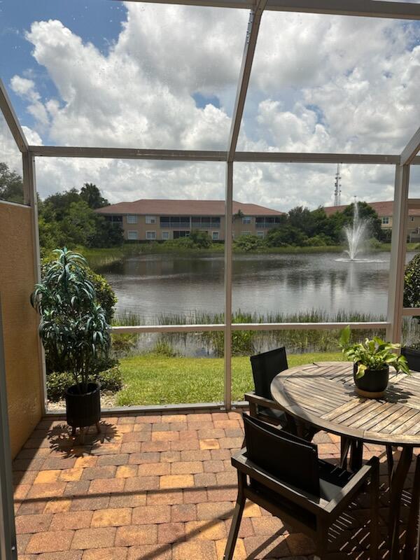 524 Southwest Glen Crest Way Stuart, FL 34997 - Photo 12 of 43 a view of a lake from a balcony with a table and chairs