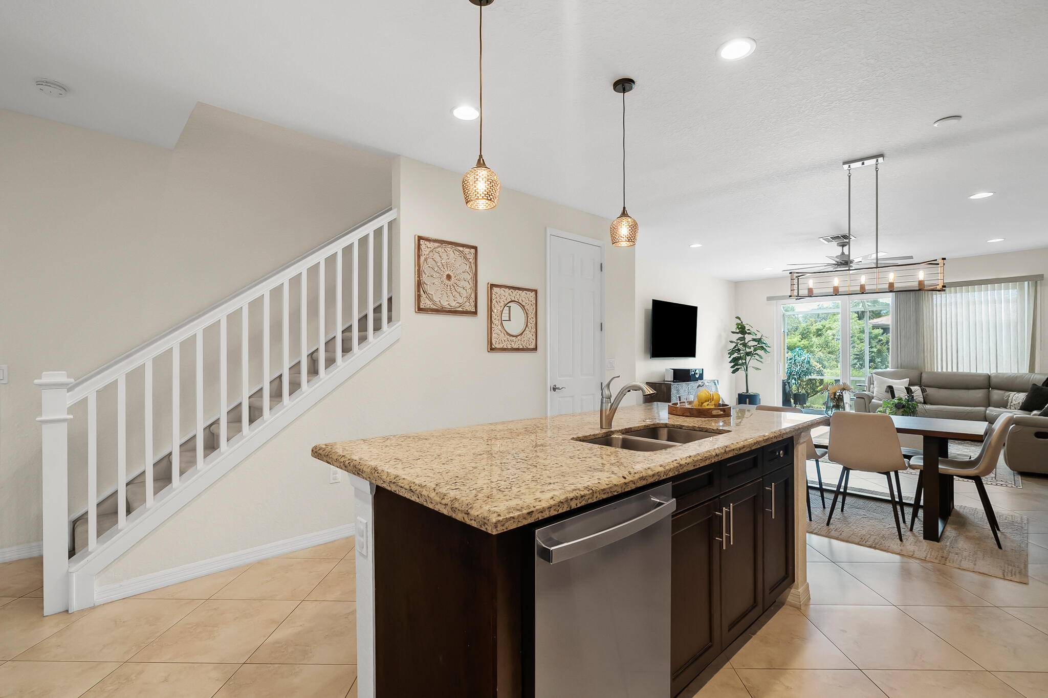 524 Southwest Glen Crest Way Stuart, FL 34997 - Photo 20 of 43 a kitchen with stainless steel appliances granite countertop a sink and a table
