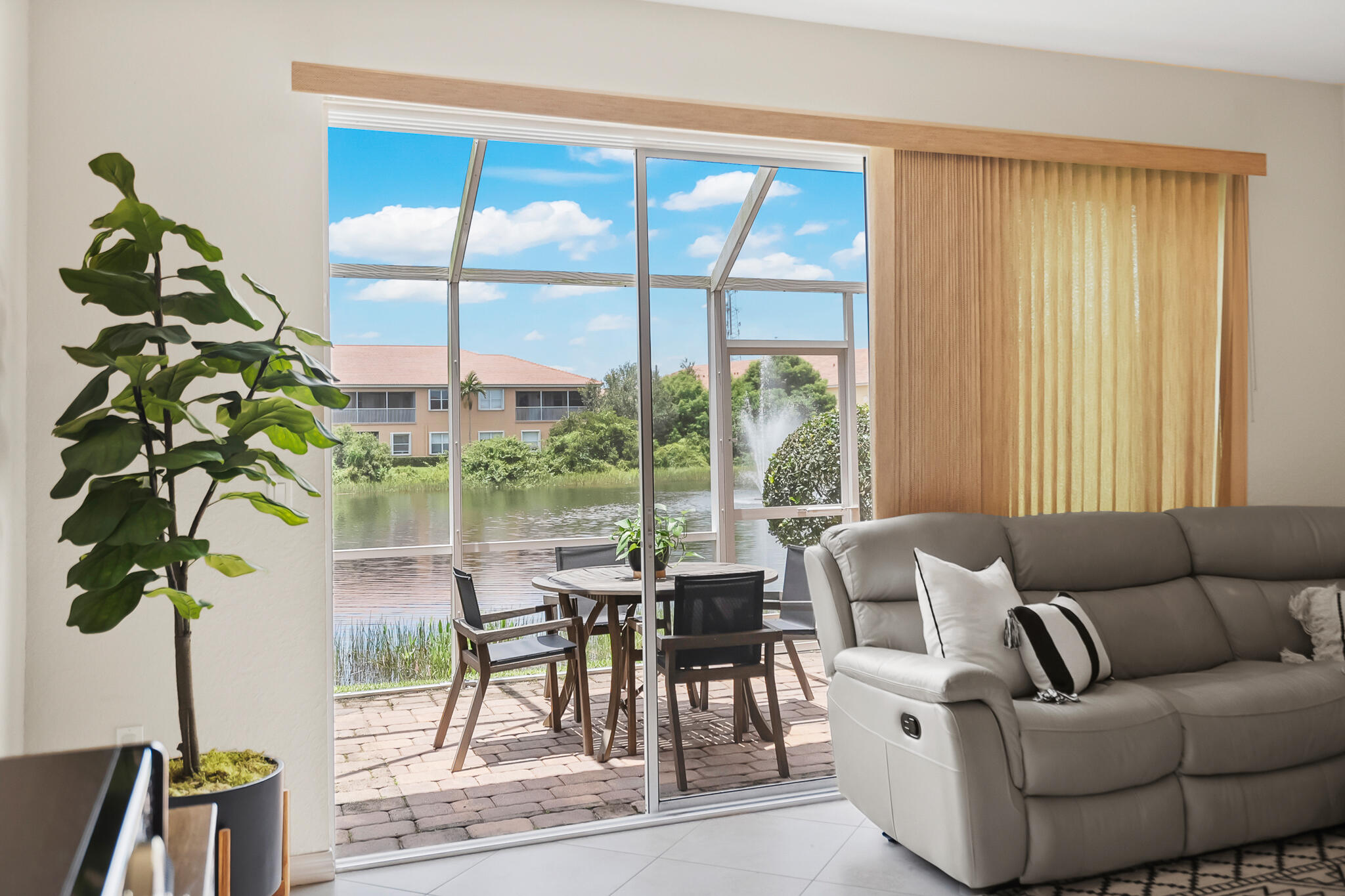 524 Southwest Glen Crest Way Stuart, FL 34997 - Photo 2 of 43 a living room with furniture plant and a large window