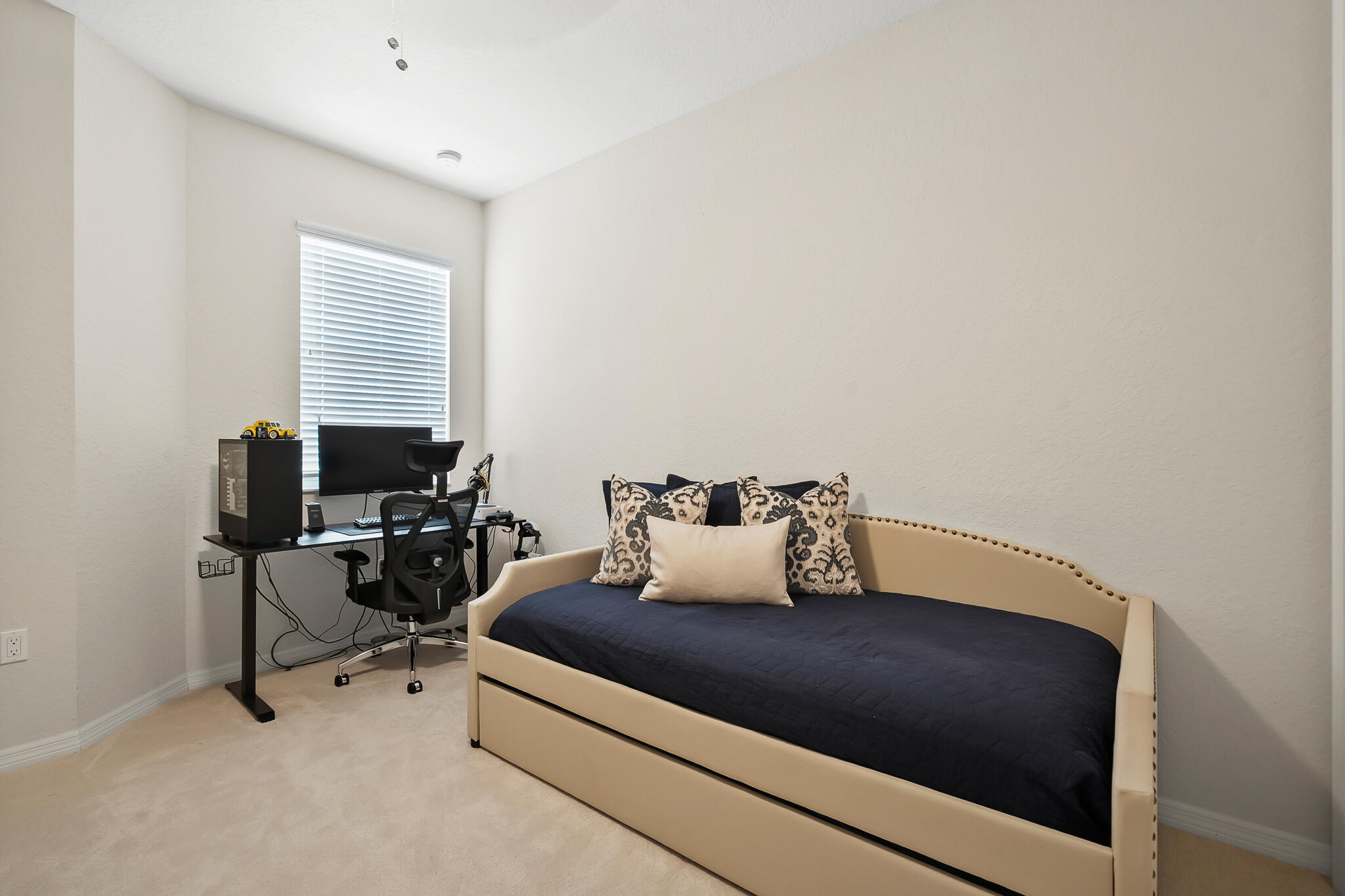 524 Southwest Glen Crest Way Stuart, FL 34997 - Photo 31 of 43 a bedroom with a bed a desk and chair