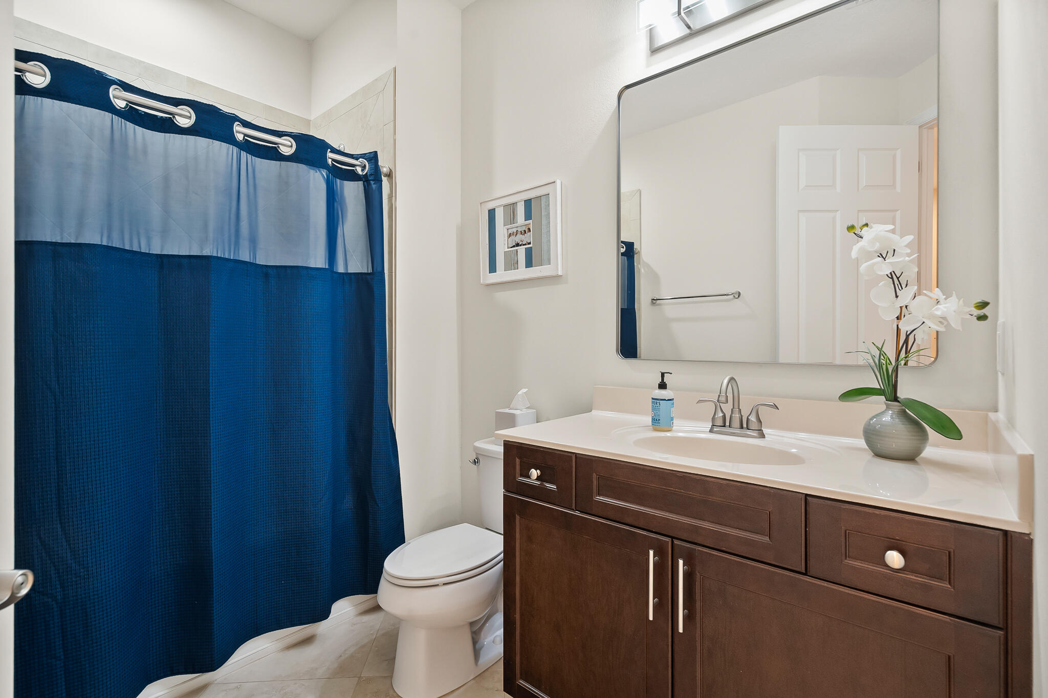 524 Southwest Glen Crest Way Stuart, FL 34997 - Photo 33 of 43 a bathroom with a sink a toilet and mirror