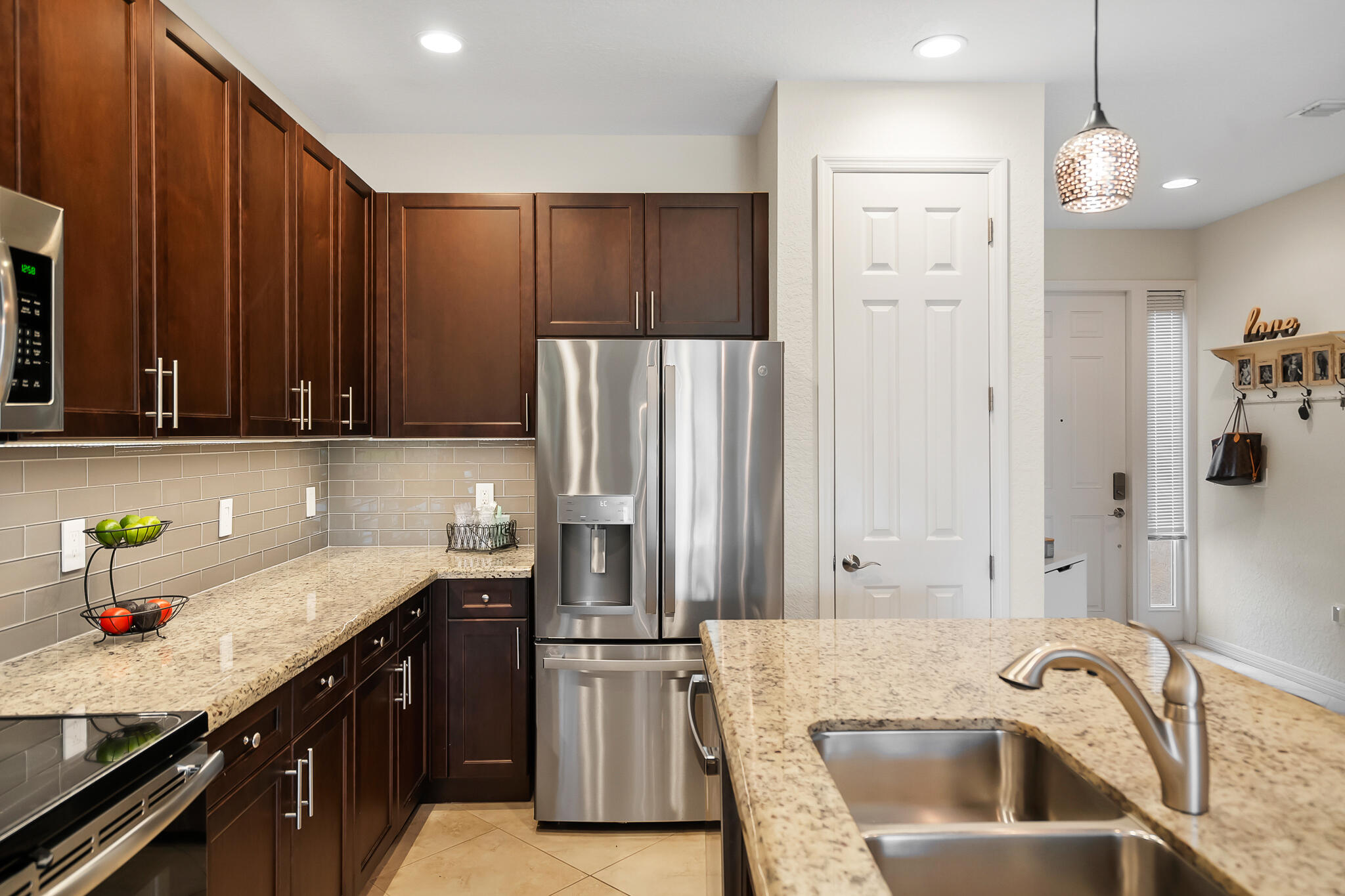 524 Southwest Glen Crest Way Stuart, FL 34997 - Photo 10 of 43 a kitchen with a sink and a refrigerator